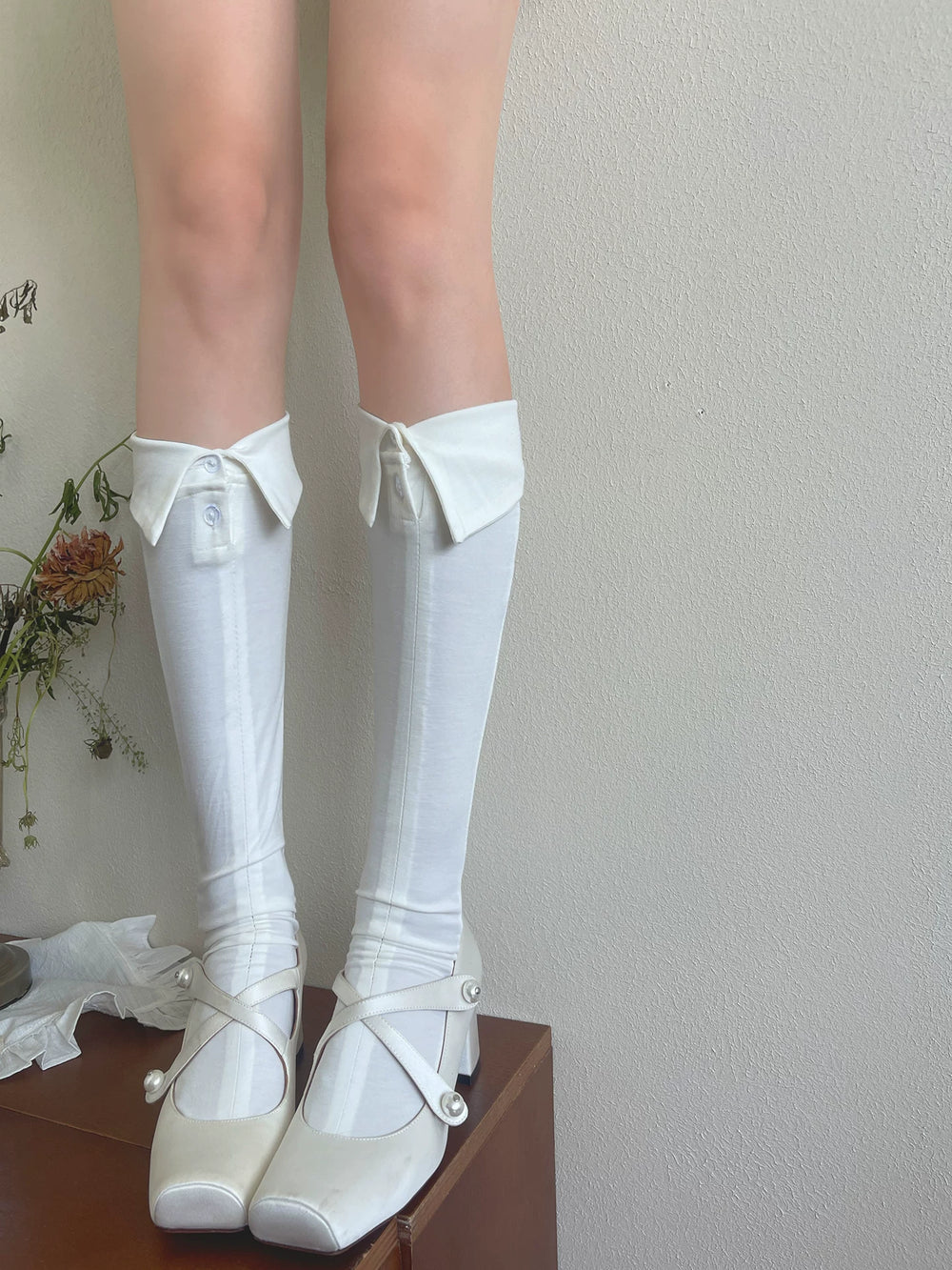 White collared button-front slouch socks shown in long and short styling