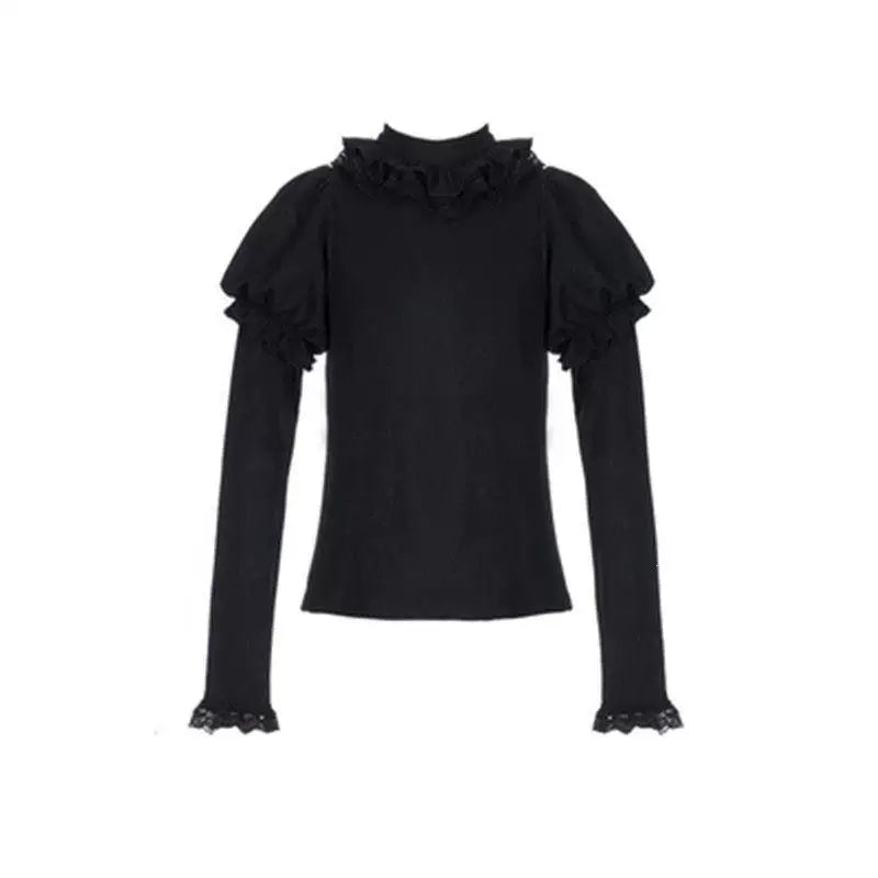 Knitted inner layer with puff sleeves and lace trim in a layered outfit