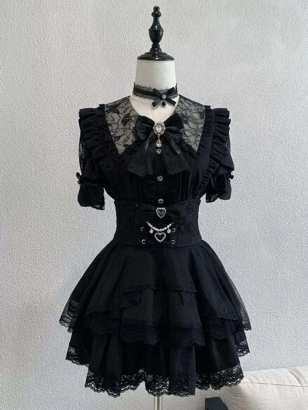 Creamy black short-sleeve blouse, skirt and bow tie set with lace collar.