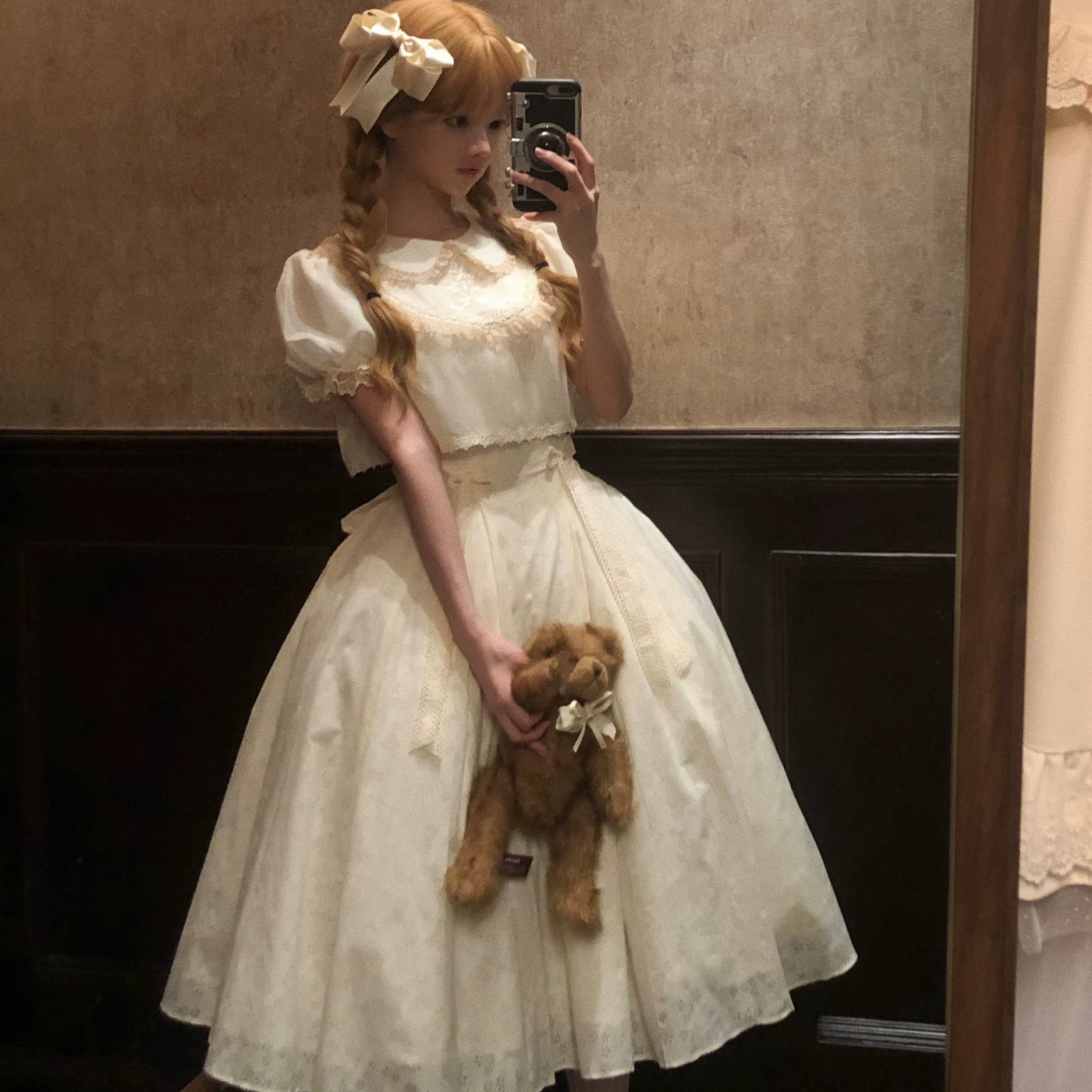 White JSK with a lace-trimmed neckline and full floral-patterned skirt.