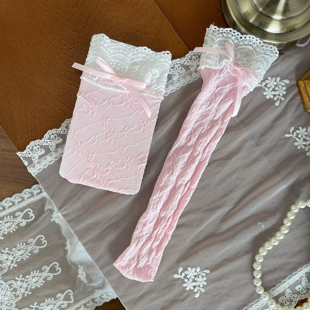 Pink and white lace over-the-knee socks with ruffled trims and ribbon ties