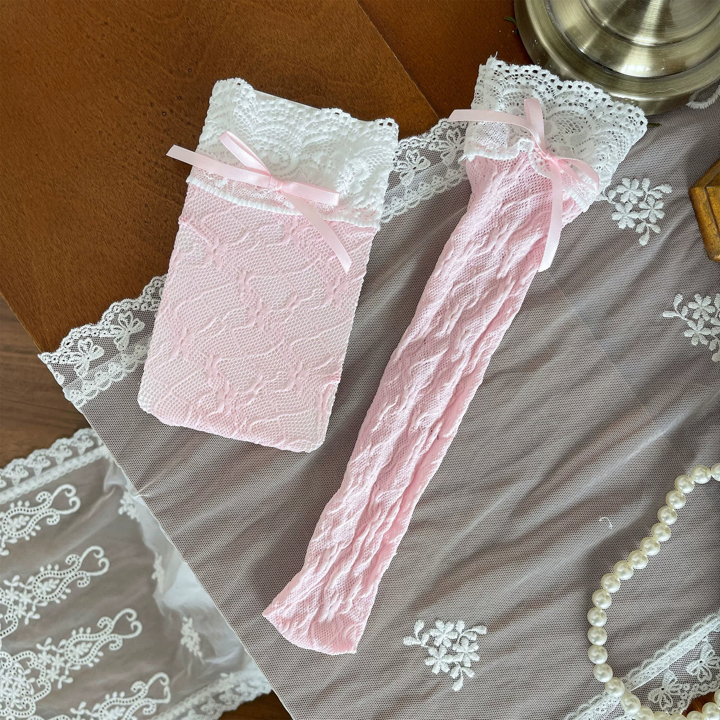 Pink and white lace over-the-knee socks with ruffled trims and ribbon ties