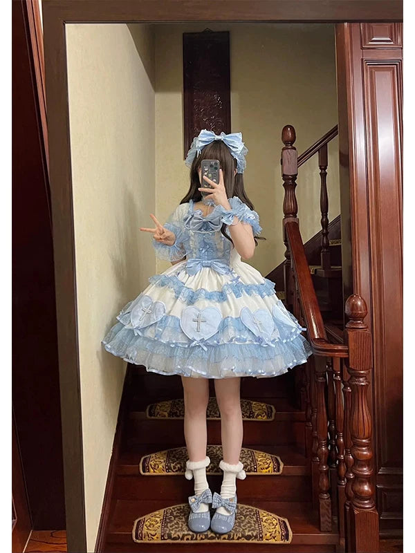 Blue-and-white short-sleeve Lolita dress with layered ruffles, bows and cross-marked heart appliqués