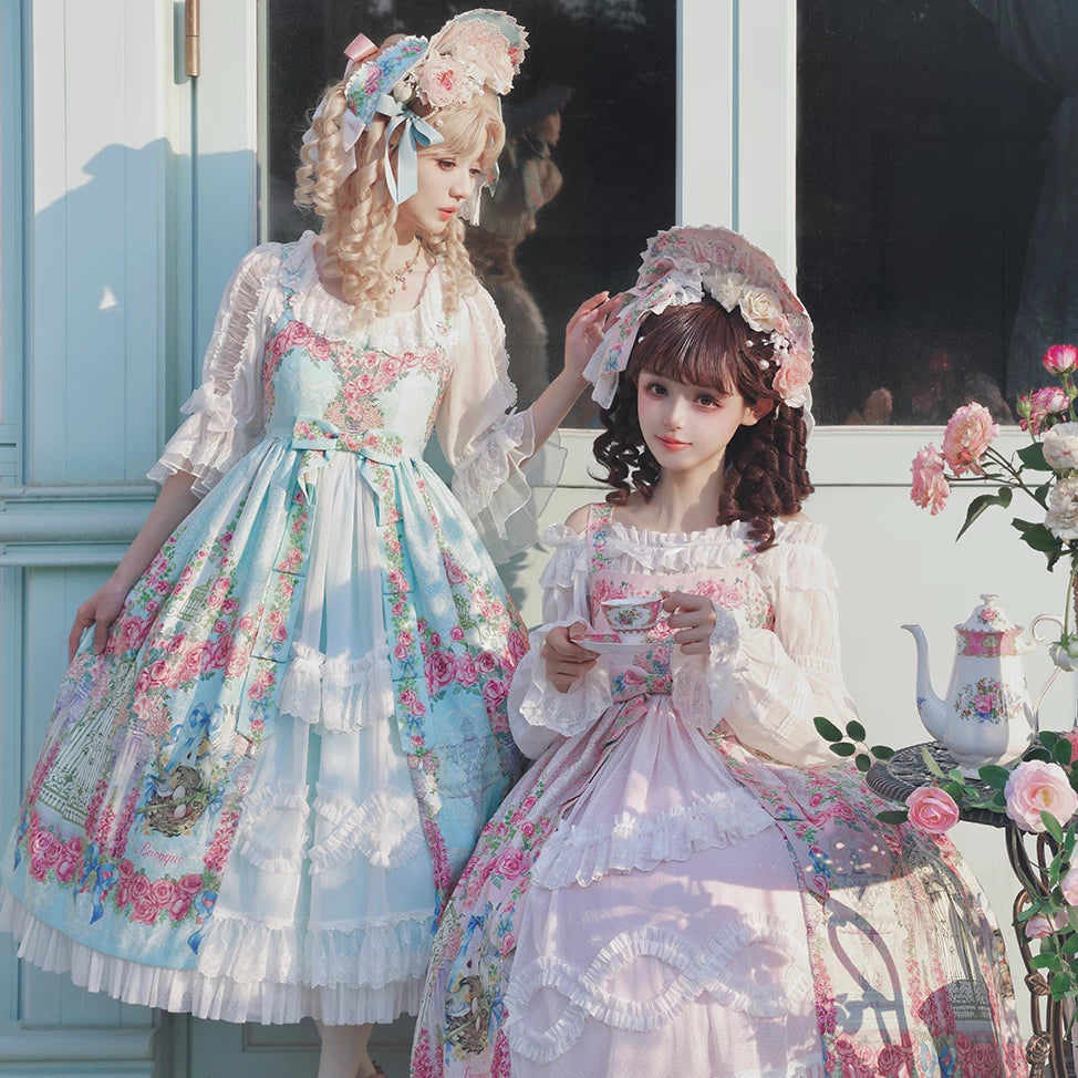 Two models wearing floral Secret Garden Lolita dresses with lace and rose details.