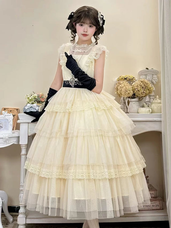 Model wearing an ivory flutter-sleeve OP dress with a tiered tulle skirt and black waist belt.