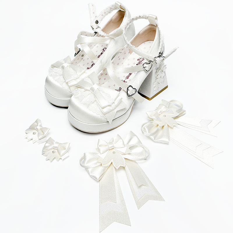 White satin Lolita shoes with bows, floral details and detachable accessories.