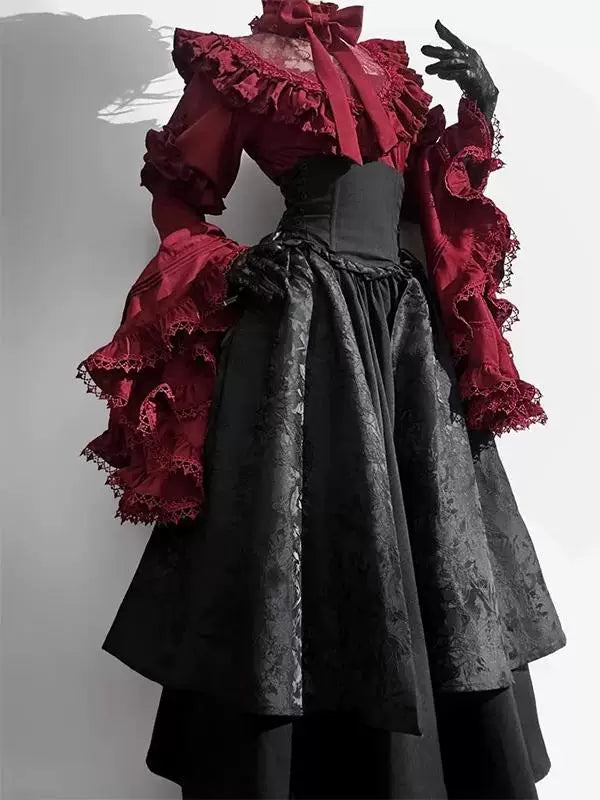 Red ruffled blouse and black skirt set displayed on a dress form.