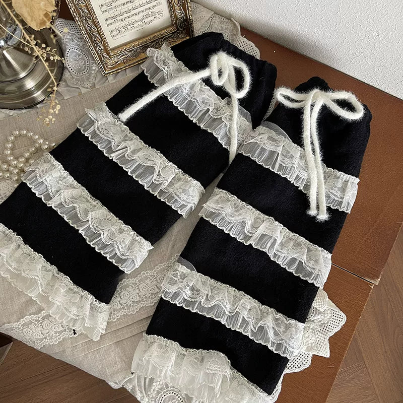 Y2K black and white layered lace sock covers with ruffles and ribbon ties.