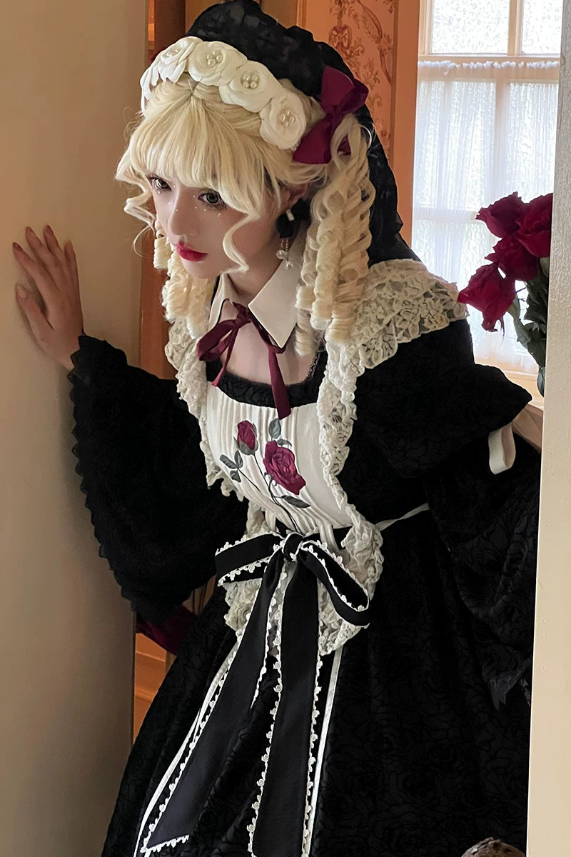 Black rose-embroidered Gothic Lolita OP dress with white lace trim and a large back bow on a mannequin