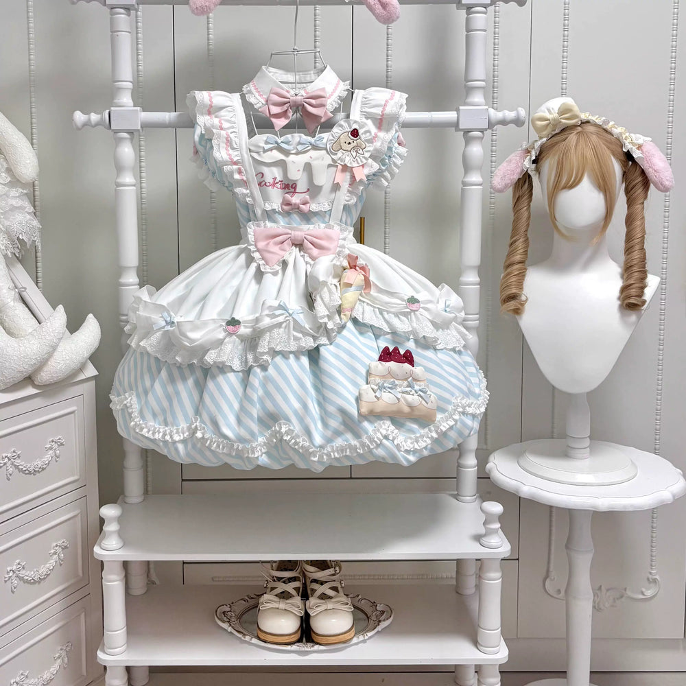 Pink and white OP dress with bows and layered ruffles hanging on a white display rack.