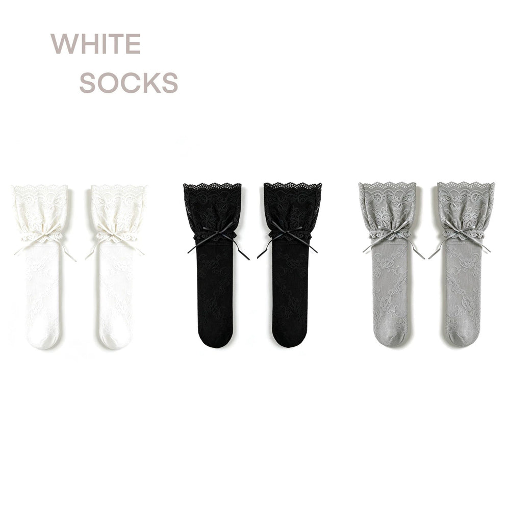 White lace mesh mid-calf socks with ribbon ties shown with a black-and-white shoe.