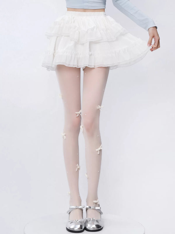 Milk-white bow and pearl pantyhose styled beneath a white ruffled skirt.