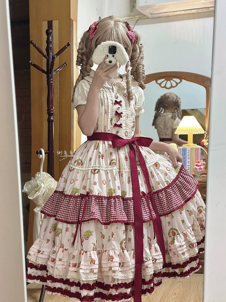 Close-up of red grosgrain waist bow and gingham tier trim on the JSK