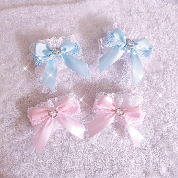 Blue and pink lace bow cuff colorways with heart accents