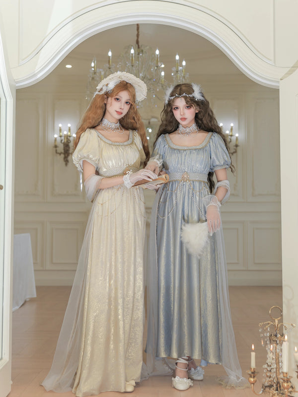 Long red empire-waist OP dress with bright beaded trim in a formal interior.