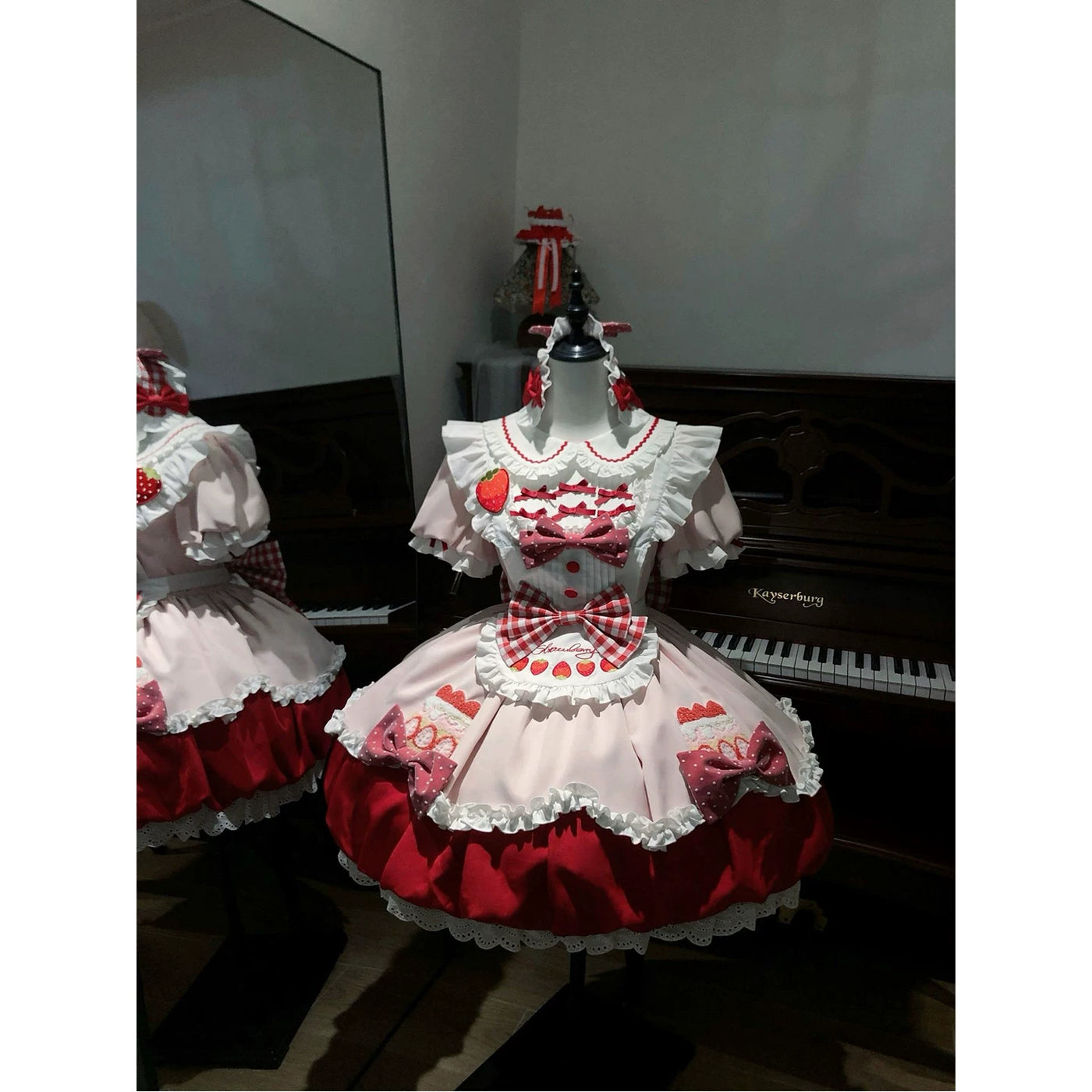 Close-up of gingham bow and strawberry motif details on the JSK bodice