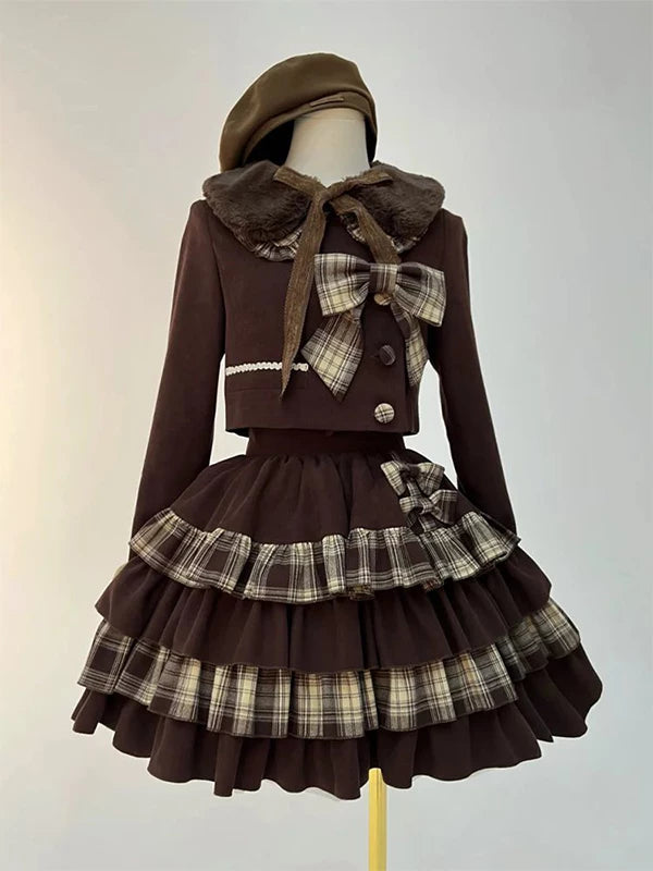 Brown cropped jacket and tiered skirt set with plaid ruffles on a mannequin.