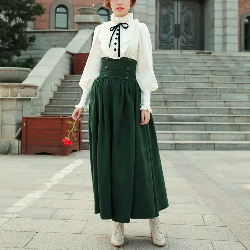 Model wearing a dark-green full skirt with a ruffled white blouse and black bow tie