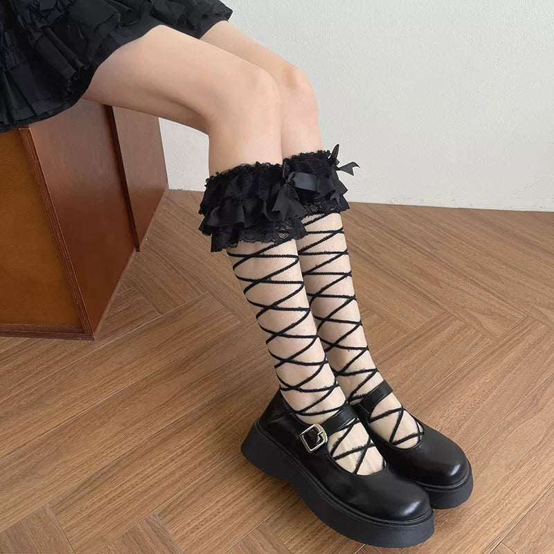 White long stockings with crisscross ties, lace cuffs and bows
