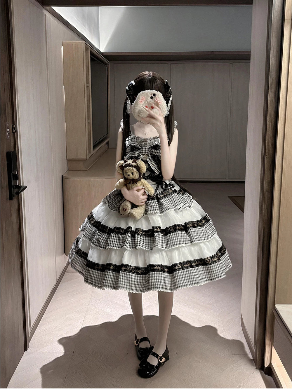 Black-and-white gingham OP dress with tiered ruffles and ribbon bands