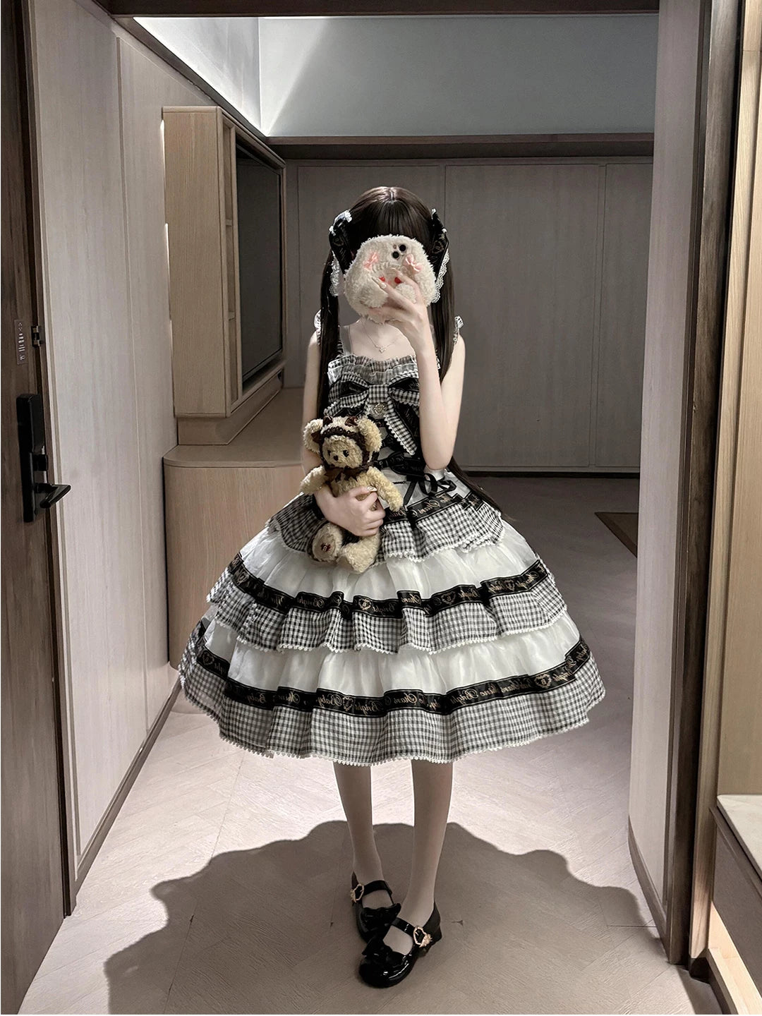 Black-and-white gingham OP dress with tiered ruffles and ribbon bands