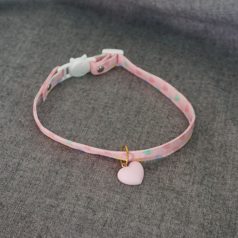Pink patterned Lolita choker with a heart-shaped pendant and buckle.