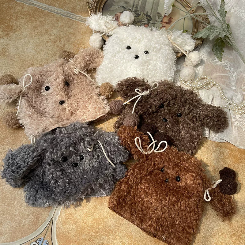 Curly dog-face leg warmers in several earthy colours arranged in a flat lay.
