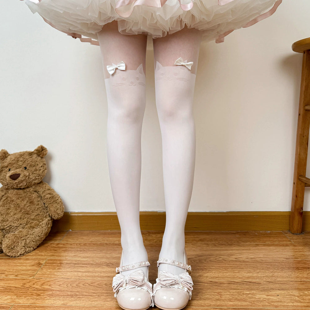White tights with cat motifs and bows styled beneath a layered skirt.