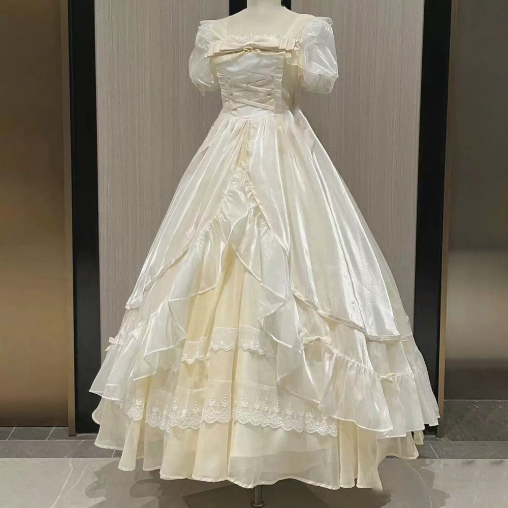 Long ivory and black-red tiered-ruffle princess dresses displayed on mannequins.