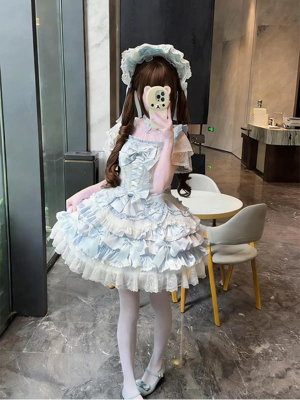 Model wearing a pale blue Lolita dress set with layered ruffles and bows