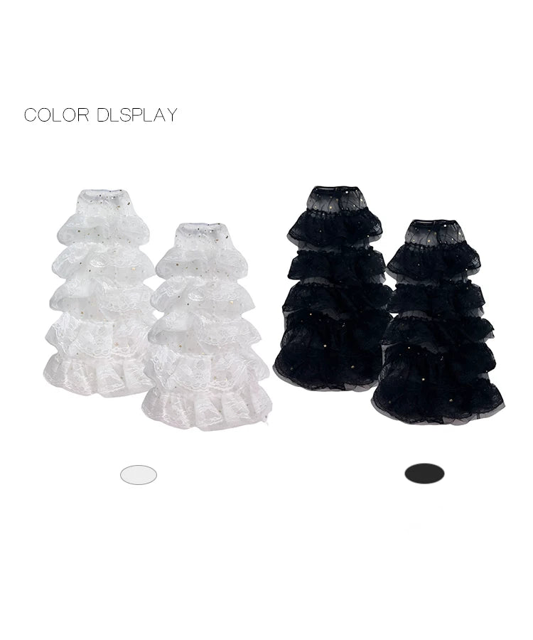 White and black layered lace leg warmers displayed in stacked ruffled tiers.