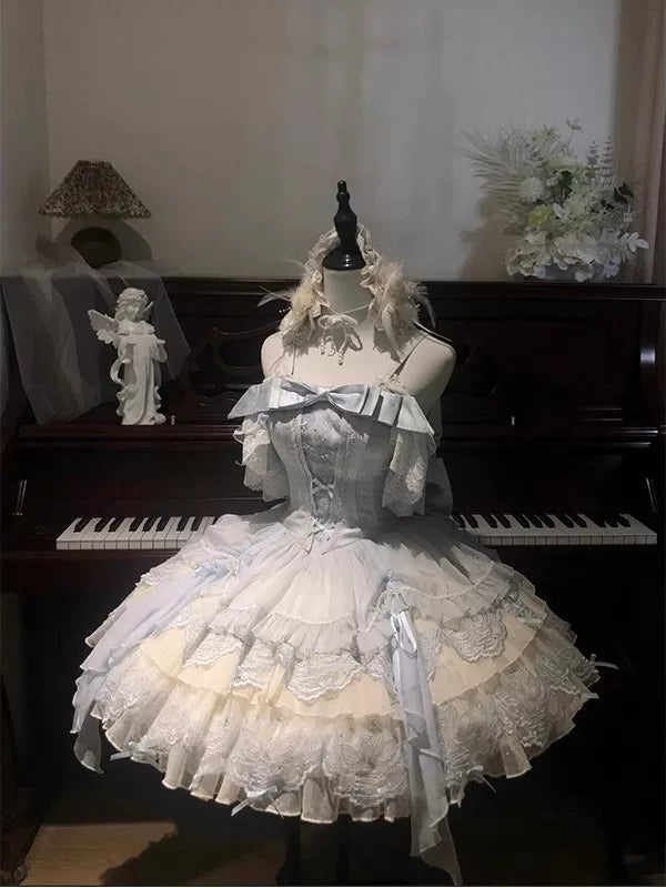 Blue ruffled Lolita JSK dress with lace layers, bows, and a train displayed on a mannequin.