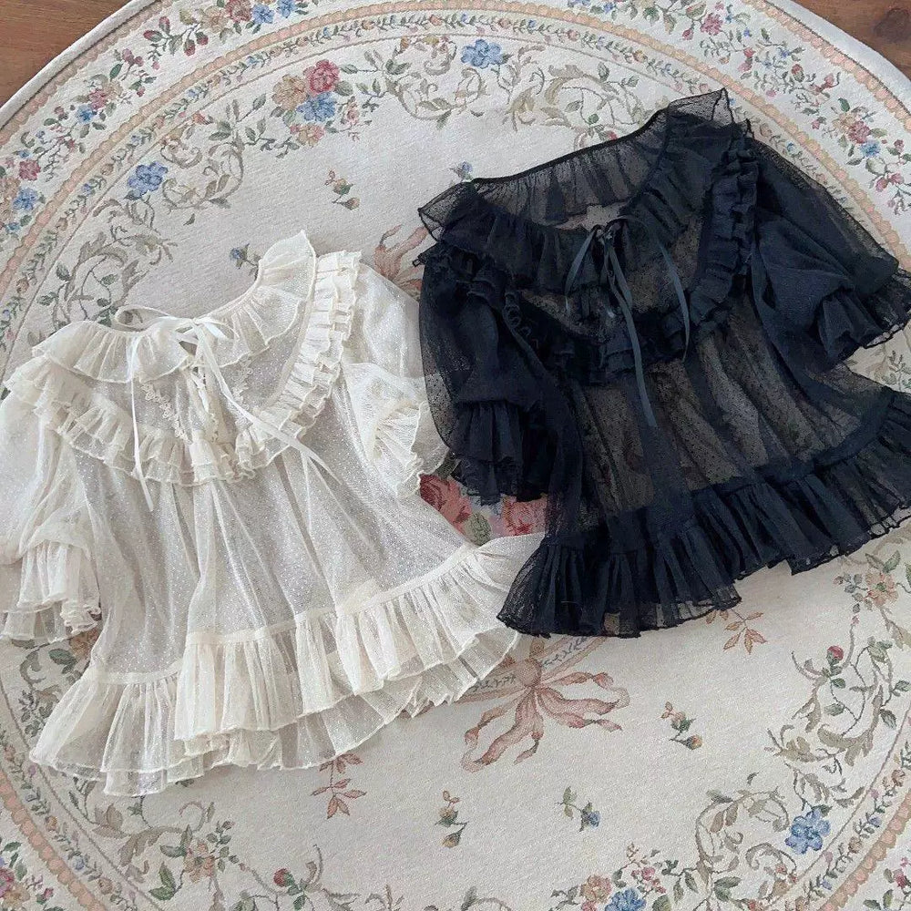 Natural-color and black short-sleeve lace blouses with layered ruffles laid flat