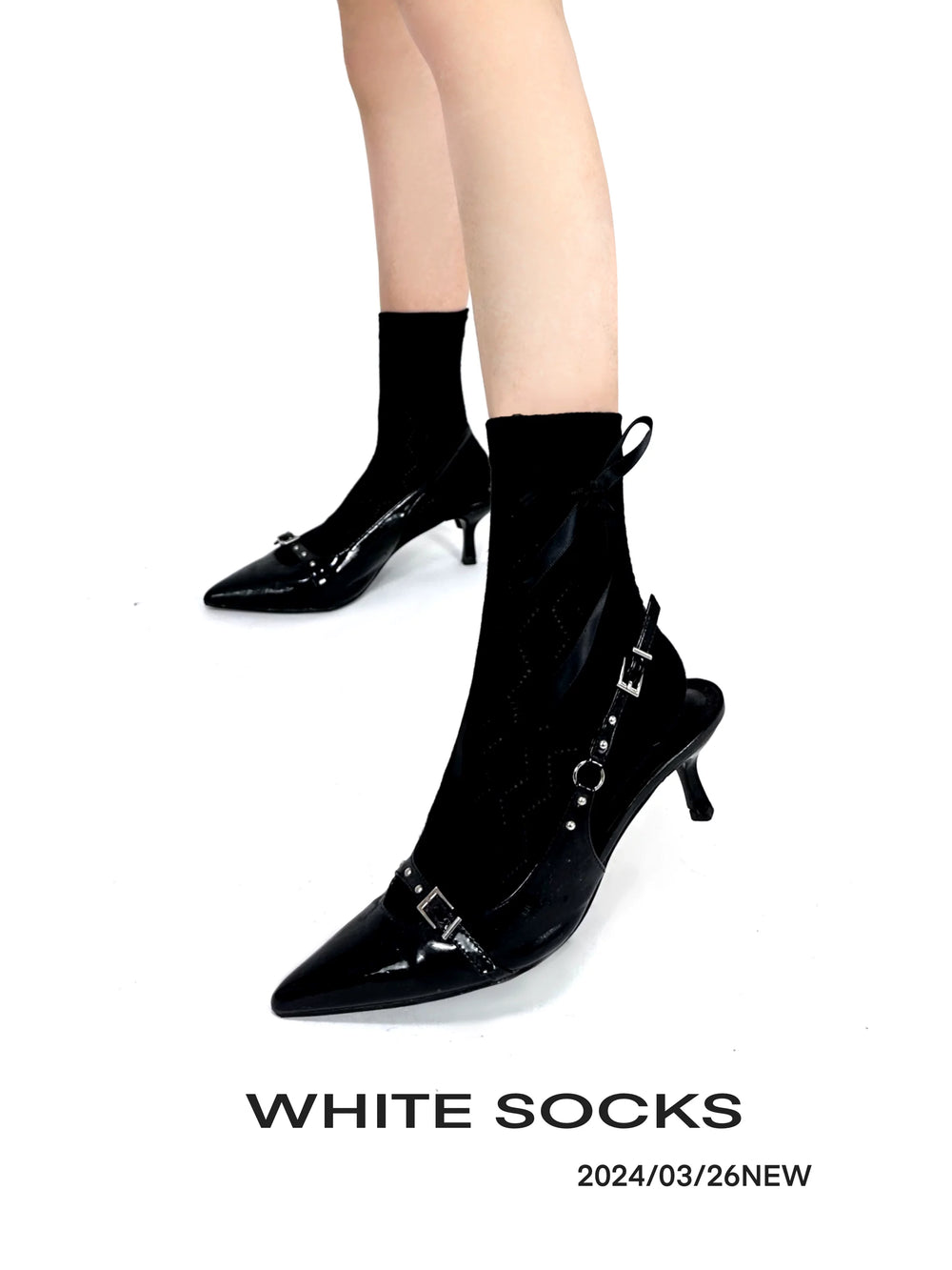 Black and white mid-calf socks with ballet-style bow straps shown with shoes.