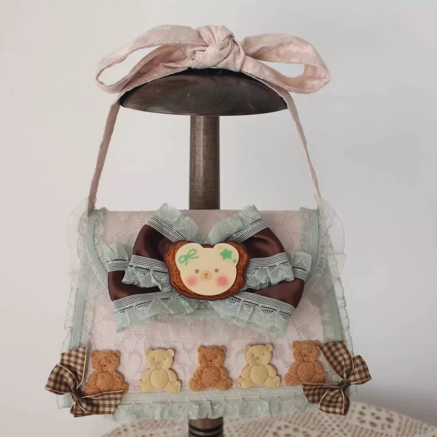 Mint and chocolate Lolita headwear and accessory options displayed on stands.