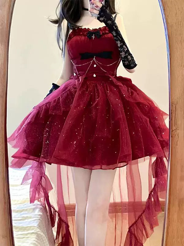 Red glitter tulle Lolita princess dress with a full skirt, trailing train, black bows, and waist chains.