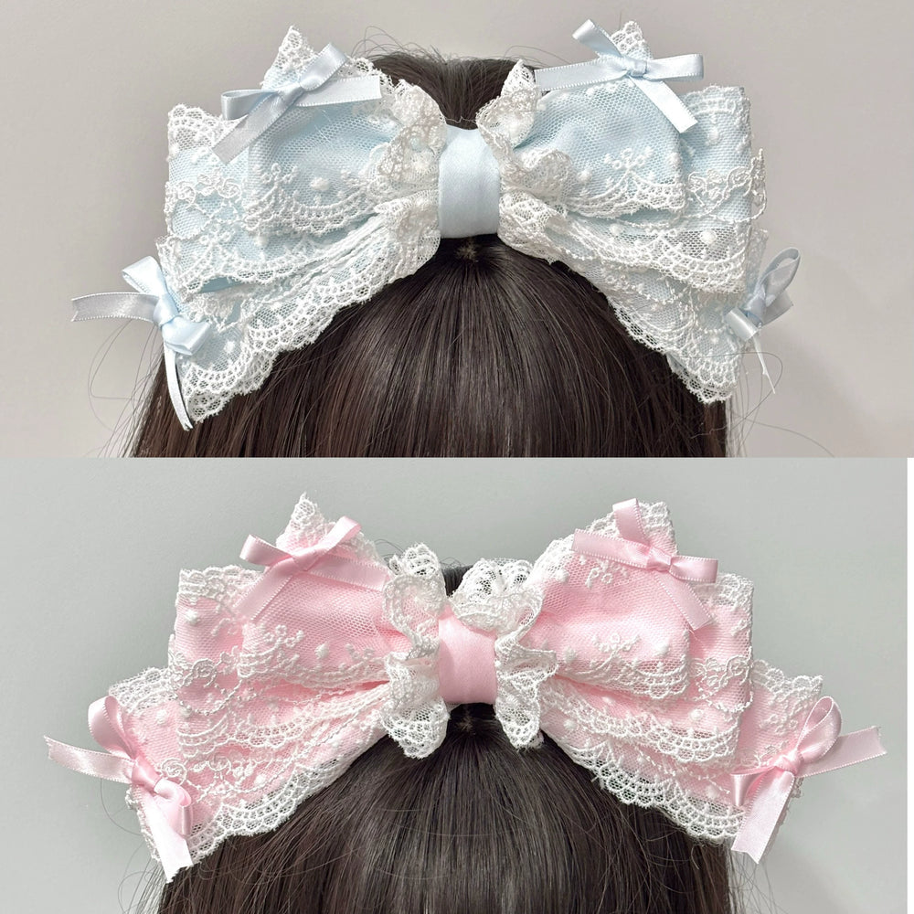 Cat Tart lace-trimmed KC hair accessories in blue and pink with large bows