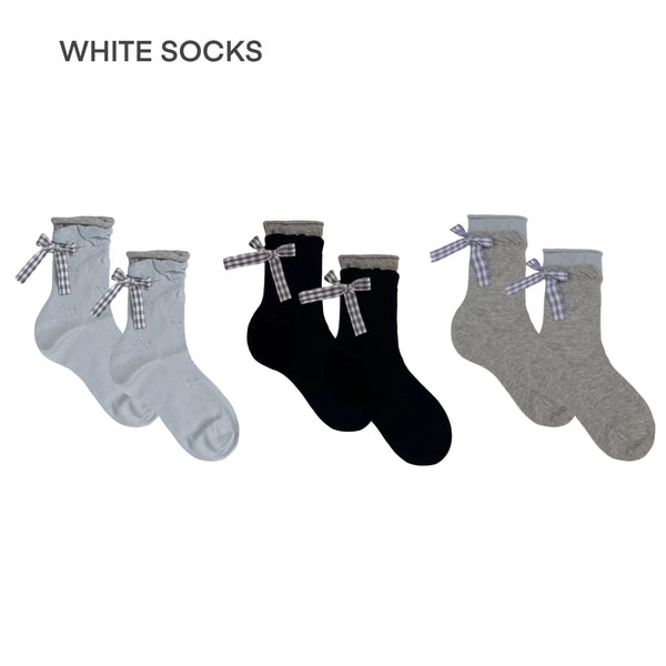 Mid-calf socks with folded striped cuffs and small bow accent, styled with ballet flats and a tiered ruffled skirt