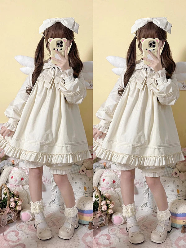 White long-sleeve ruffled blouse-and-shorts outfit with a large neck bow.