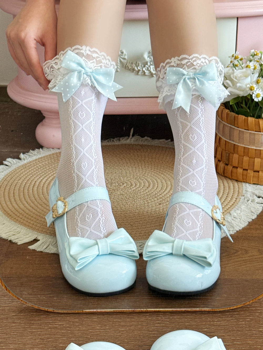 White patterned mid-calf socks with lace cuffs and pink bows styled with pale pink Mary Janes