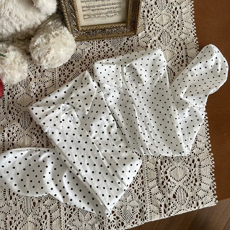 White polka-dot calf socks with black bow accents styled with black platform loafers.