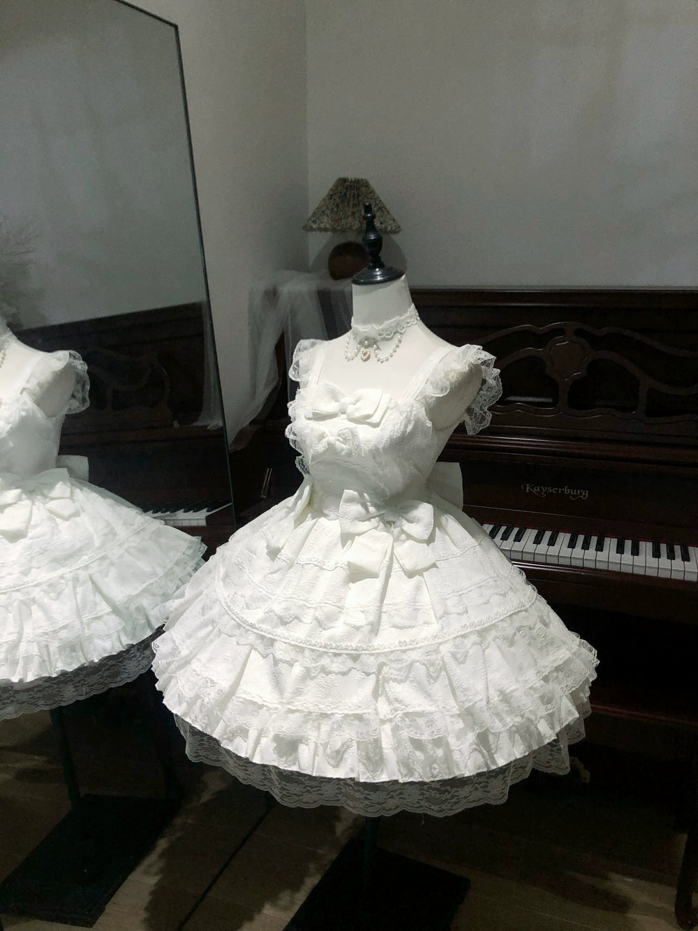 Detail view of tiered skirt with horizontal lace inserts and scalloped hem finish