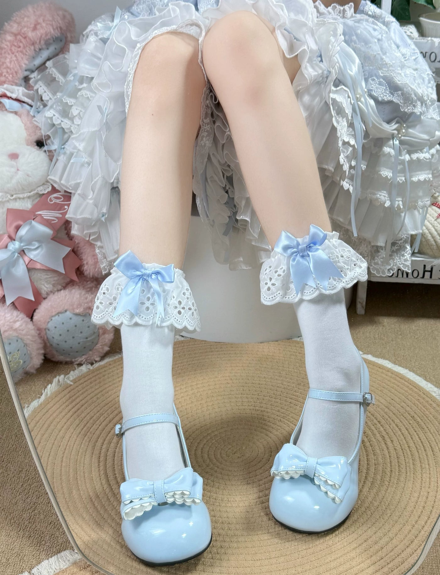 Fantasy Doll white mid-calf socks with scalloped lace cuffs and bows styled with pale blue shoes.