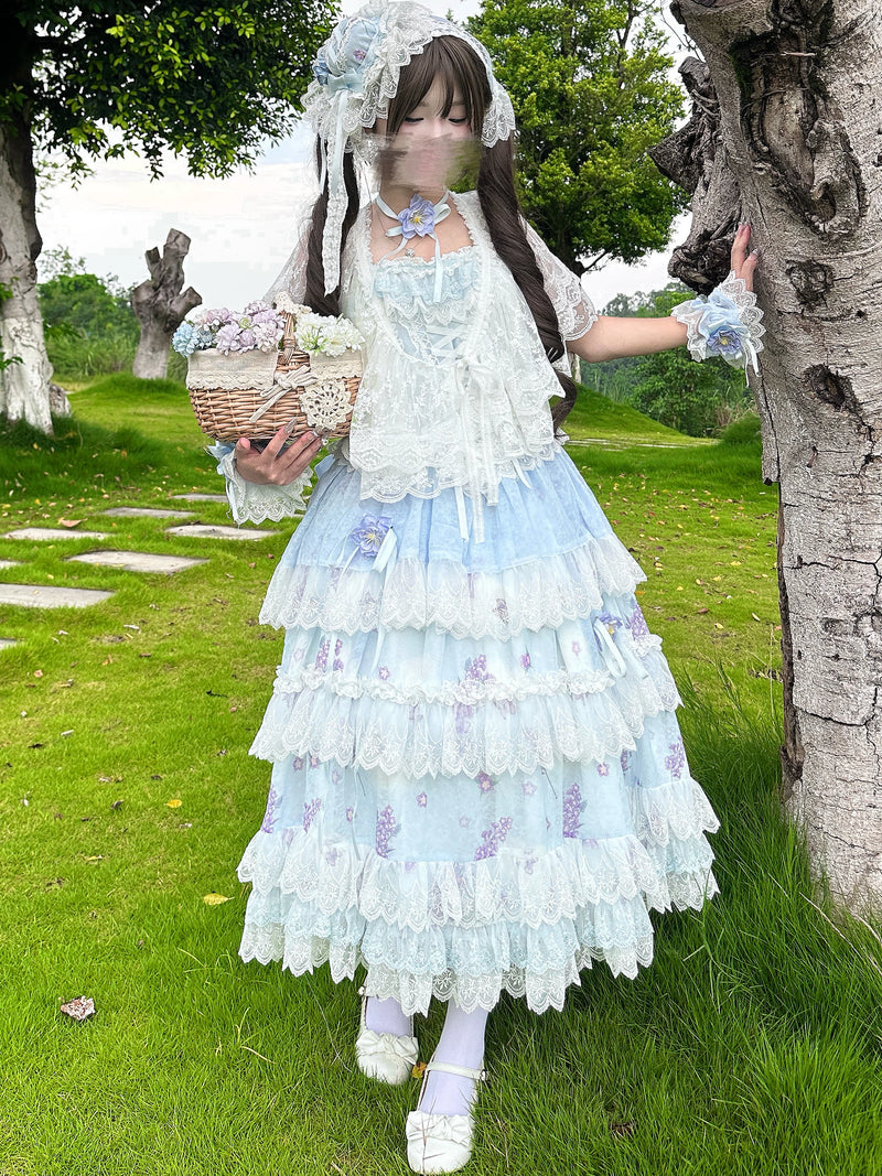 Detail of scalloped lace trim between tiered skirt layers and floral print fabric