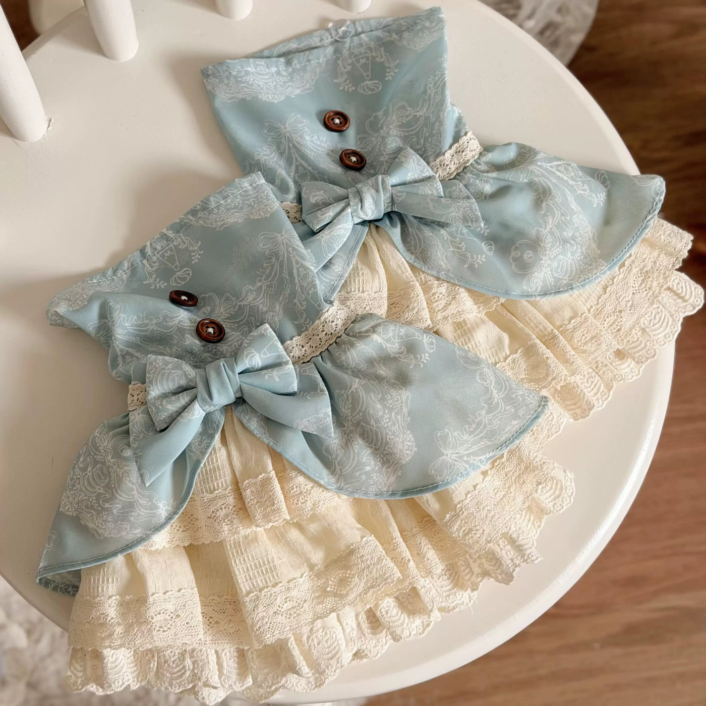 Blue and beige Lolita dresses shown flat and styled in a storybook-inspired editorial scene.