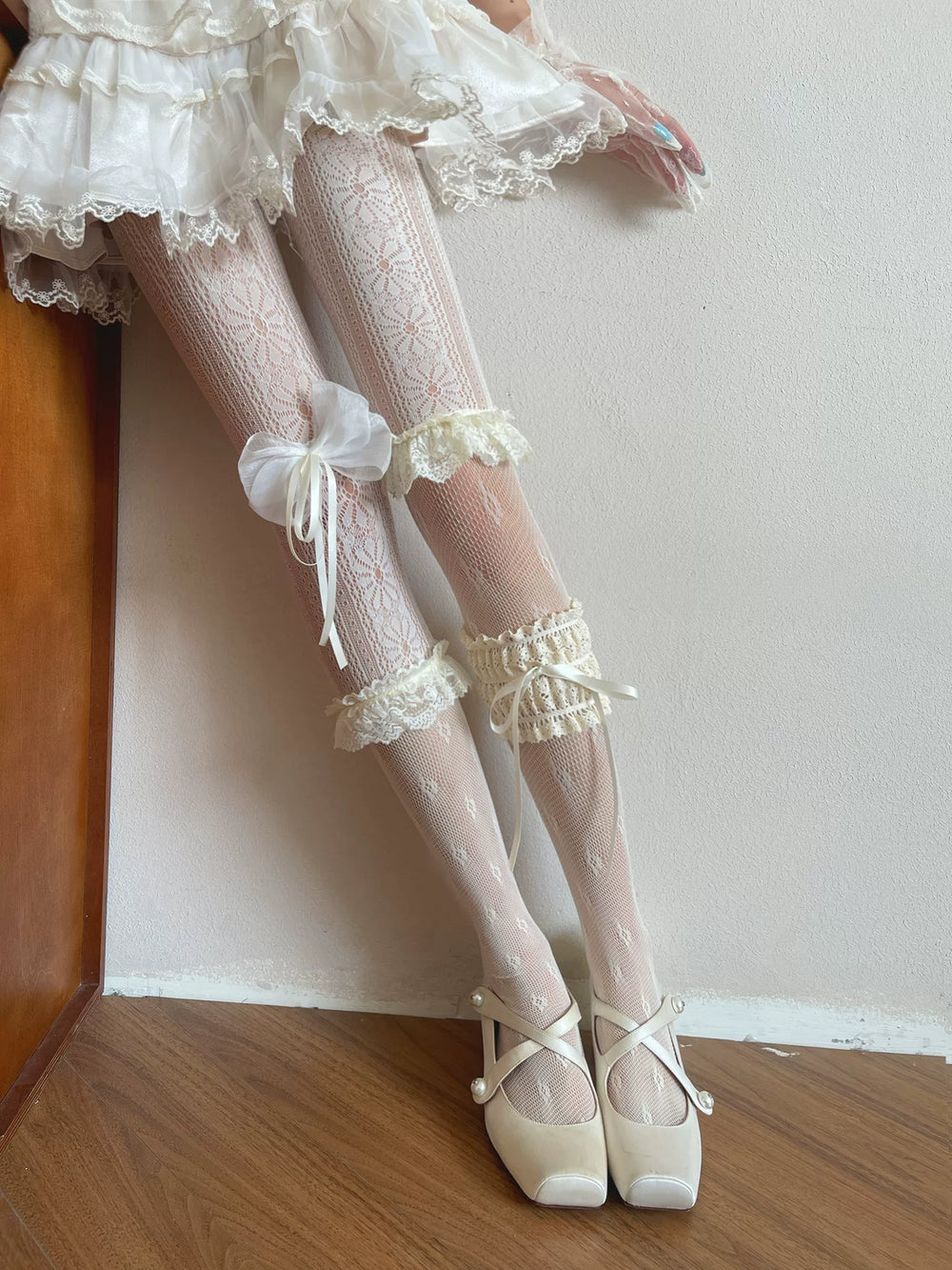 Lace tights and ruffled leg garters styled beneath a layered skirt