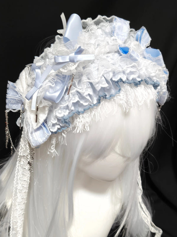 Aqua-blue lace headband with bows and hanging accents on a white wig
