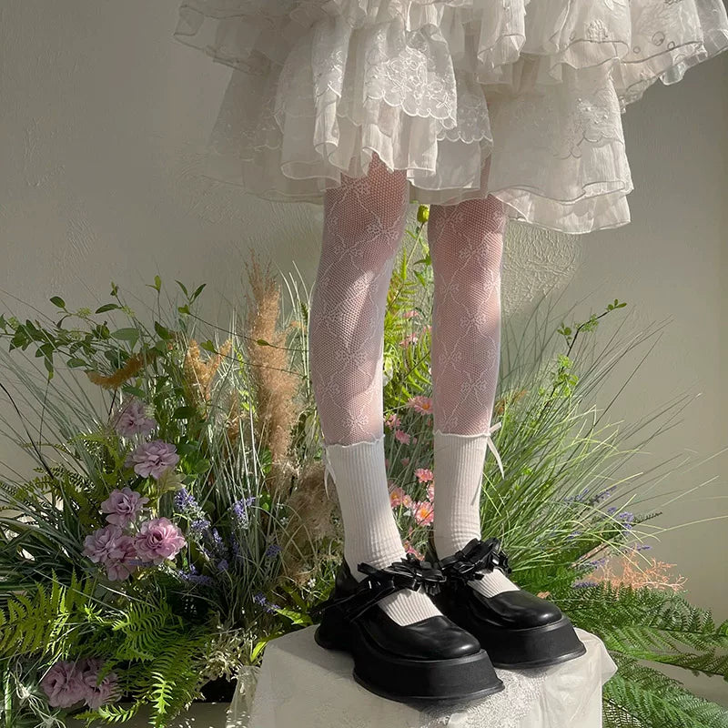Sock Noble lace-patterned tights styled with platform Mary Jane shoes