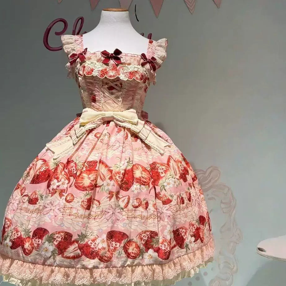 Blush pink Sweet Lolita JSK with all-over strawberry print, corset lacing, and tiered ruffled skirt