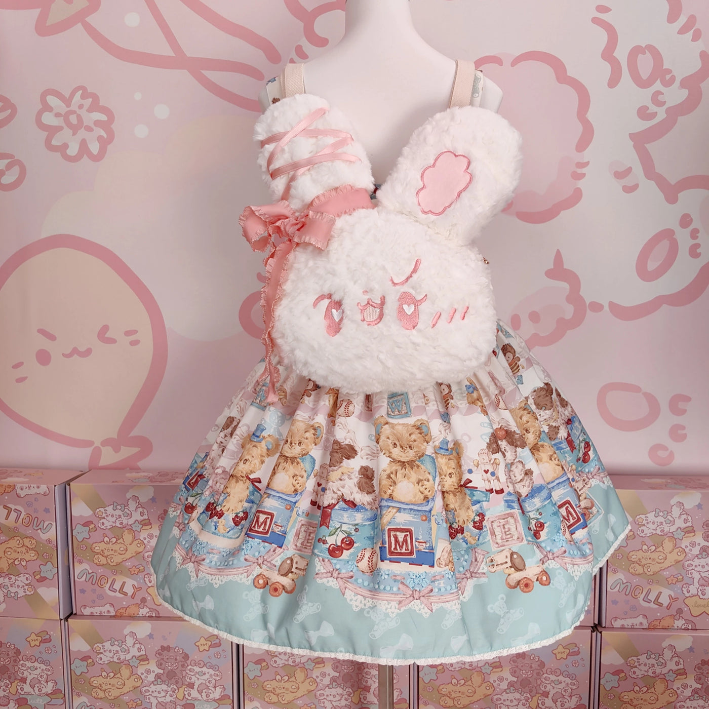 Molly Puppy plush white bunny backpack with pink ribbon detailing shown on a mannequin.